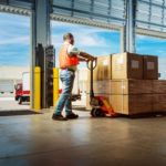 worker with hand pallet truck